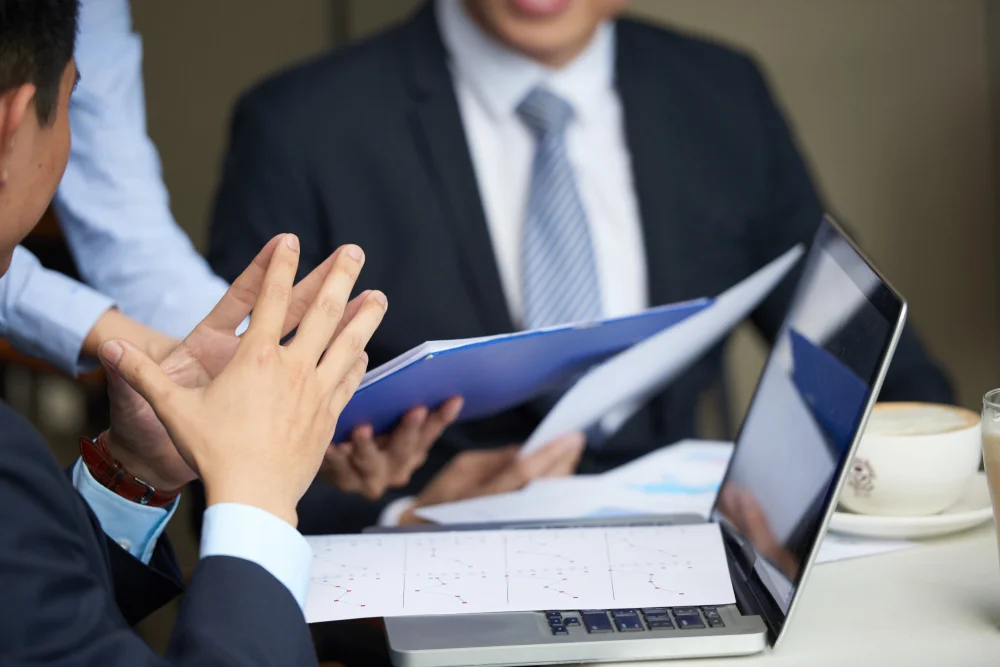Corporate boardroom meeting focused on why legal operations and risk compliance are important for organizations, with executives and legal counsel discussing AI safety